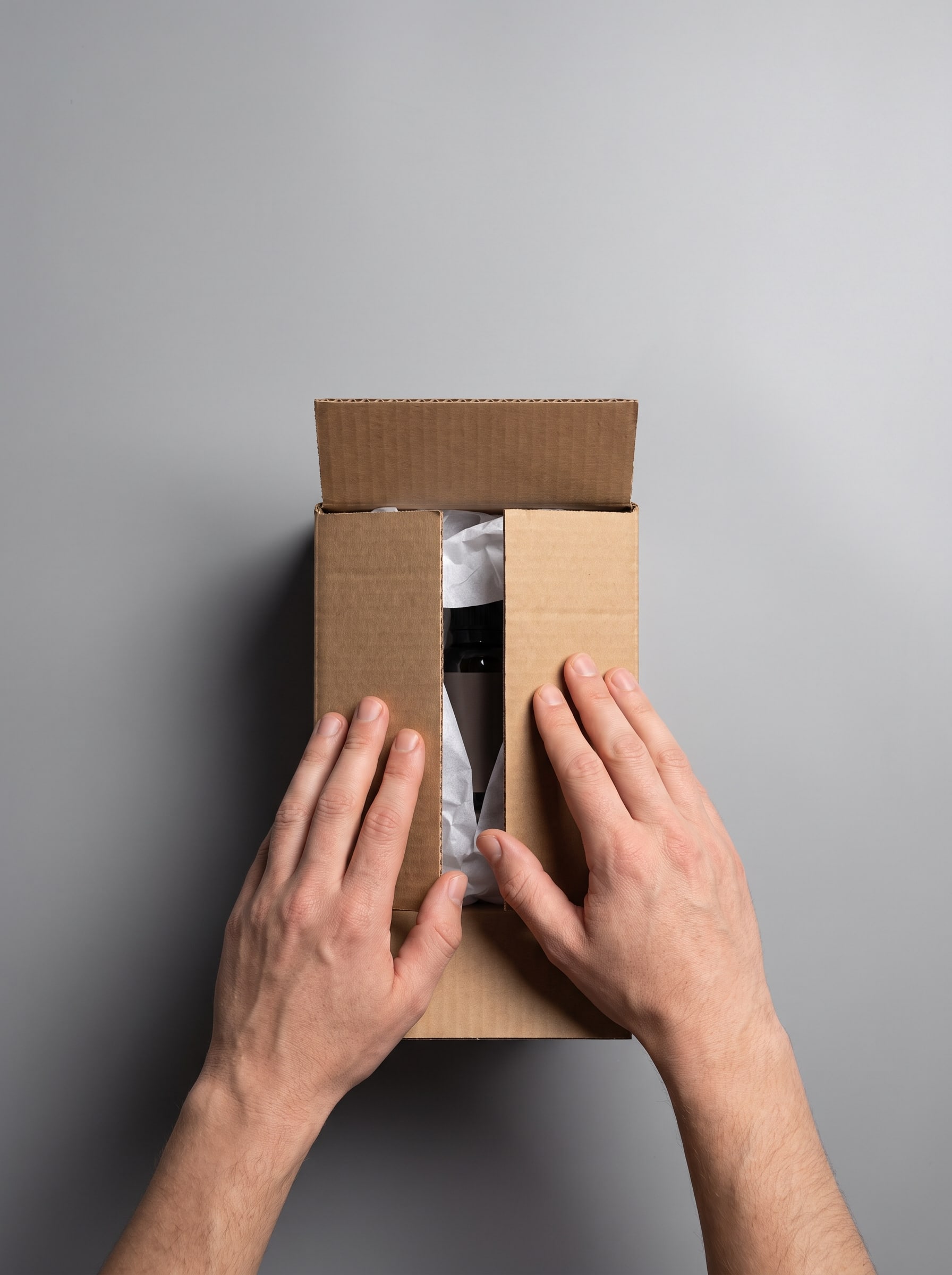 Person unboxing a cardboard package